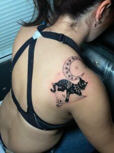 tatuaje de una pantera negra con una luna