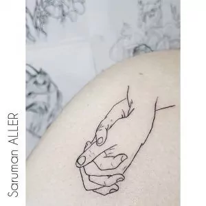 Tatuaje manos entrelazadas estilo minimalista con líneas finas