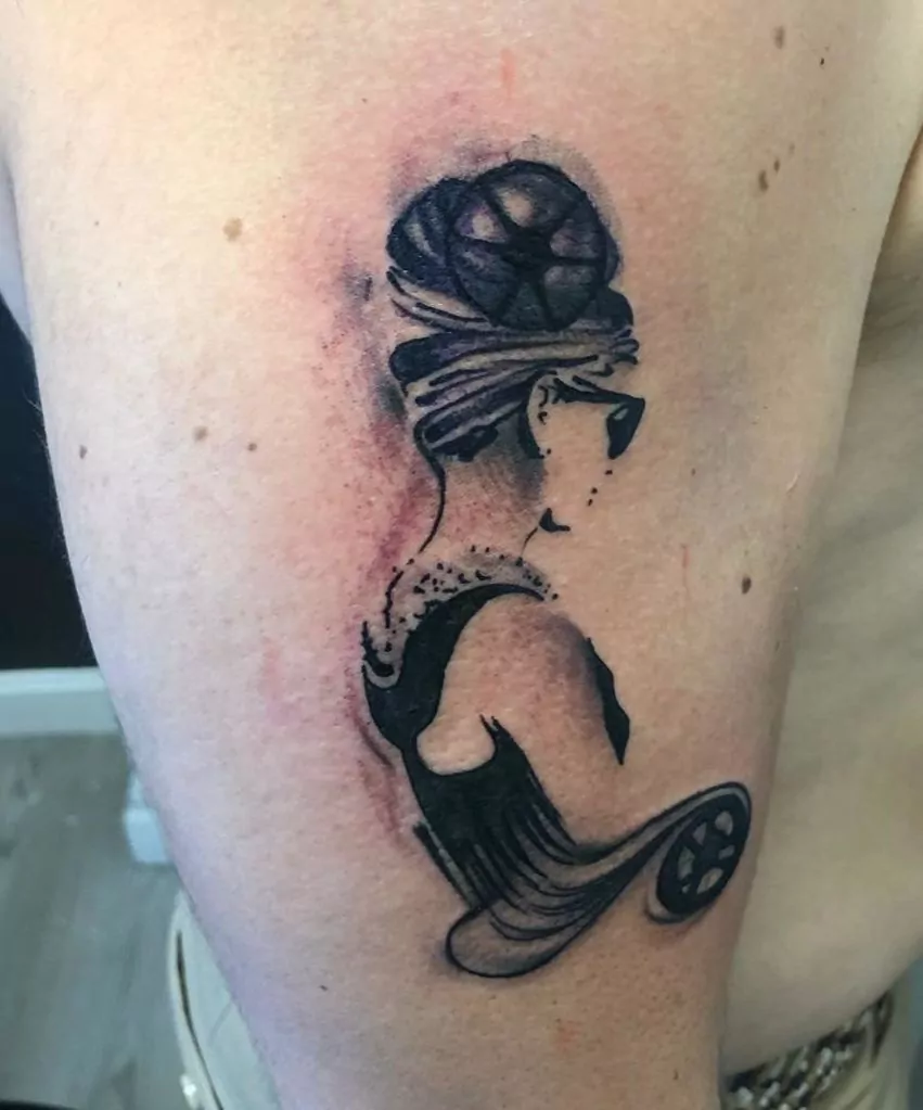 Tatuaje del personaje principal de desayuno con Tiffany's en el brazo